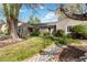 Landscaped front yard with mature trees, a well manicured lawn and attractive rock border at 4550 Zephyr St, Wheat Ridge, CO 80033