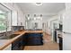 Bright kitchen with butcher block countertops, subway tile backsplash, and updated cabinetry at 4550 Zephyr St, Wheat Ridge, CO 80033
