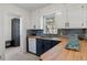 Charming kitchen with butcher block countertops, stylish backsplash, and white upper cabinets at 4550 Zephyr St, Wheat Ridge, CO 80033
