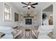 Inviting living room with a stone fireplace, built-in shelving and modern ceiling fan at 4550 Zephyr St, Wheat Ridge, CO 80033