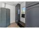 Well-organized mud room with storage cabinets, bench seating, and a bright window at 4550 Zephyr St, Wheat Ridge, CO 80033
