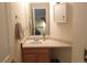 A well-lit bathroom features a single sink, cabinet, large mirror and matching medicine cabinet at 2240 S Pagosa Ct # B, Aurora, CO 80013