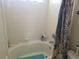 The bathroom features a white-tiled tub, shower combination with a patterned shower curtain at 2240 S Pagosa Ct # B, Aurora, CO 80013