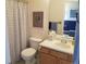 This compact bathroom features a cozy toilet, sink, and bath with a patterned curtain at 2240 S Pagosa Ct # B, Aurora, CO 80013
