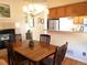Inviting dining room with hardwood floors, fireplace, and a view into the kitchen at 2240 S Pagosa Ct # B, Aurora, CO 80013