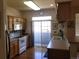 Efficient kitchen layout with stainless steel appliances and sliding glass door to balcony at 2240 S Pagosa Ct # B, Aurora, CO 80013