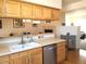 Functional kitchen with breakfast bar, stainless dishwasher and connection to the dining room at 2240 S Pagosa Ct # B, Aurora, CO 80013