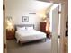A light and airy main bedroom with white walls and carpet features a queen bed and tasteful decor at 2240 S Pagosa Ct # B, Aurora, CO 80013