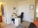 This bedroom features an office space complete with desk and is next to the bathroom at 2240 S Pagosa Ct # B, Aurora, CO 80013