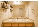 Bathroom with a double sink vanity, large mirror, and ample storage at 2479 S High St, Denver, CO 80210