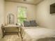 A bright bedroom with a window, desk, and neutral décor at 2479 S High St, Denver, CO 80210