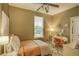A cozy bedroom with a ceiling fan, window, vanity and warm décor at 2479 S High St, Denver, CO 80210