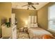 A cozy bedroom with a ceiling fan and comfortable décor at 2479 S High St, Denver, CO 80210