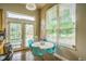 Bright dining area with contemporary seating and a view to the french doors and a large window at 2479 S High St, Denver, CO 80210