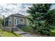 A great home exterior view featuring a patio area and green landscaping at 2479 S High St, Denver, CO 80210