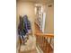 Hallway from staircase features built-in shelving and closet space at 2479 S High St, Denver, CO 80210