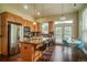 Well-lit kitchen with stainless steel appliances, a granite-topped island, and a dining area at 2479 S High St, Denver, CO 80210