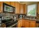 Modern kitchen featuring stainless steel appliances, granite countertops, and warm wood cabinetry at 2479 S High St, Denver, CO 80210