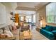 Open-concept living room with a view into the kitchen, creating a spacious and inviting atmosphere at 2479 S High St, Denver, CO 80210