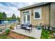 Charming patio area with outdoor seating, flowers, and a view of the well-maintained landscaping at 2479 S High St, Denver, CO 80210