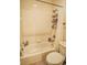 A clean bathroom featuring a shower and tub combination with tiled walls at 2479 S High St, Denver, CO 80210
