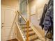 Carpeted stairs with wood and wrought iron banister lead to upper level at 2479 S High St, Denver, CO 80210
