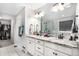 Spa-like bathroom with double vanity, sleek granite countertops, tiled floors, and spacious glass shower at 3572 Makley Cir, Castle Rock, CO 80104