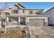 Charming two-story home featuring a covered porch, gray siding, and attached two-car garage at 3572 Makley Cir, Castle Rock, CO 80104