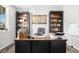 Home office featuring built-in bookcases, wooden desk, and natural light from a window at 3572 Makley Cir, Castle Rock, CO 80104