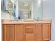 Bathroom vanity features double sinks and wooden cabinetry at 15700 E Jamison Dr # 7-203, Englewood, CO 80112