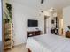 Bedroom with a TV and wood plant stand is bright and cheerful at 15700 E Jamison Dr # 7-203, Englewood, CO 80112