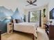 Bright bedroom featuring mountain-themed wall art and a ceiling fan at 15700 E Jamison Dr # 7-203, Englewood, CO 80112