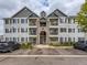 Three story apartment building featuring individual balconies and well maintained landscaping at 15700 E Jamison Dr # 7-203, Englewood, CO 80112