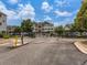 Exterior view of gated community with lush trees, landscaping, and well-maintained buildings at 15700 E Jamison Dr # 7-203, Englewood, CO 80112