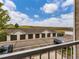 View of detached garages and parked cars from a balcony on a bright, sunny day at 15700 E Jamison Dr # 7-203, Englewood, CO 80112