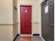 Entryway with a red door and a welcome mat, creating a warm and inviting atmosphere at 15700 E Jamison Dr # 7-203, Englewood, CO 80112