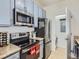 A view of a well-equipped kitchen featuring stainless steel appliances and modern finishes at 15700 E Jamison Dr # 7-203, Englewood, CO 80112