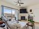 Bright living room with a cozy fireplace and access to a private balcony, perfect for relaxing at 15700 E Jamison Dr # 7-203, Englewood, CO 80112