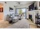 Inviting living room with a fireplace, sliding glass doors to a balcony and neutral decor at 15700 E Jamison Dr # 7-203, Englewood, CO 80112