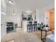 Open concept living space with kitchen, dining area, and bar seating, great for entertaining at 15700 E Jamison Dr # 7-203, Englewood, CO 80112