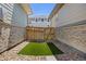 Small outdoor space with artificial turf, wood fence, and rock landscaping at 21482 E 60Th Ave, Aurora, CO 80019