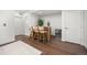 Basement bar area featuring bar with stools, hardwood floors, and built-in drink storage at 21482 E 60Th Ave, Aurora, CO 80019