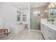 Bright bathroom featuring freestanding tub, glass shower, large window, and modern vanity with sink at 21482 E 60Th Ave, Aurora, CO 80019