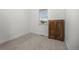 Neutral bedroom features carpet, large window, and vintage cabinet at 21482 E 60Th Ave, Aurora, CO 80019