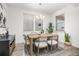 Bright dining room with modern decor, stylish table setting, and ample natural light from large windows at 21482 E 60Th Ave, Aurora, CO 80019