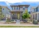 Charming two-story home with a modern exterior, landscaped yard, and a welcoming yellow front door at 21482 E 60Th Ave, Aurora, CO 80019