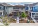 A charming two-story home features a covered porch, modern design, and neatly landscaped front yard at 21482 E 60Th Ave, Aurora, CO 80019