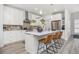 Bright modern kitchen with a large island, stainless steel appliances, and stylish bar stools at 21482 E 60Th Ave, Aurora, CO 80019