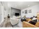 Charming living room featuring a stylish leather sofa, modern decor, and a cozy atmosphere at 21482 E 60Th Ave, Aurora, CO 80019