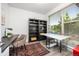 Bright office space with large window, modern desk setup, and stylish bookshelves for a productive workspace at 21482 E 60Th Ave, Aurora, CO 80019